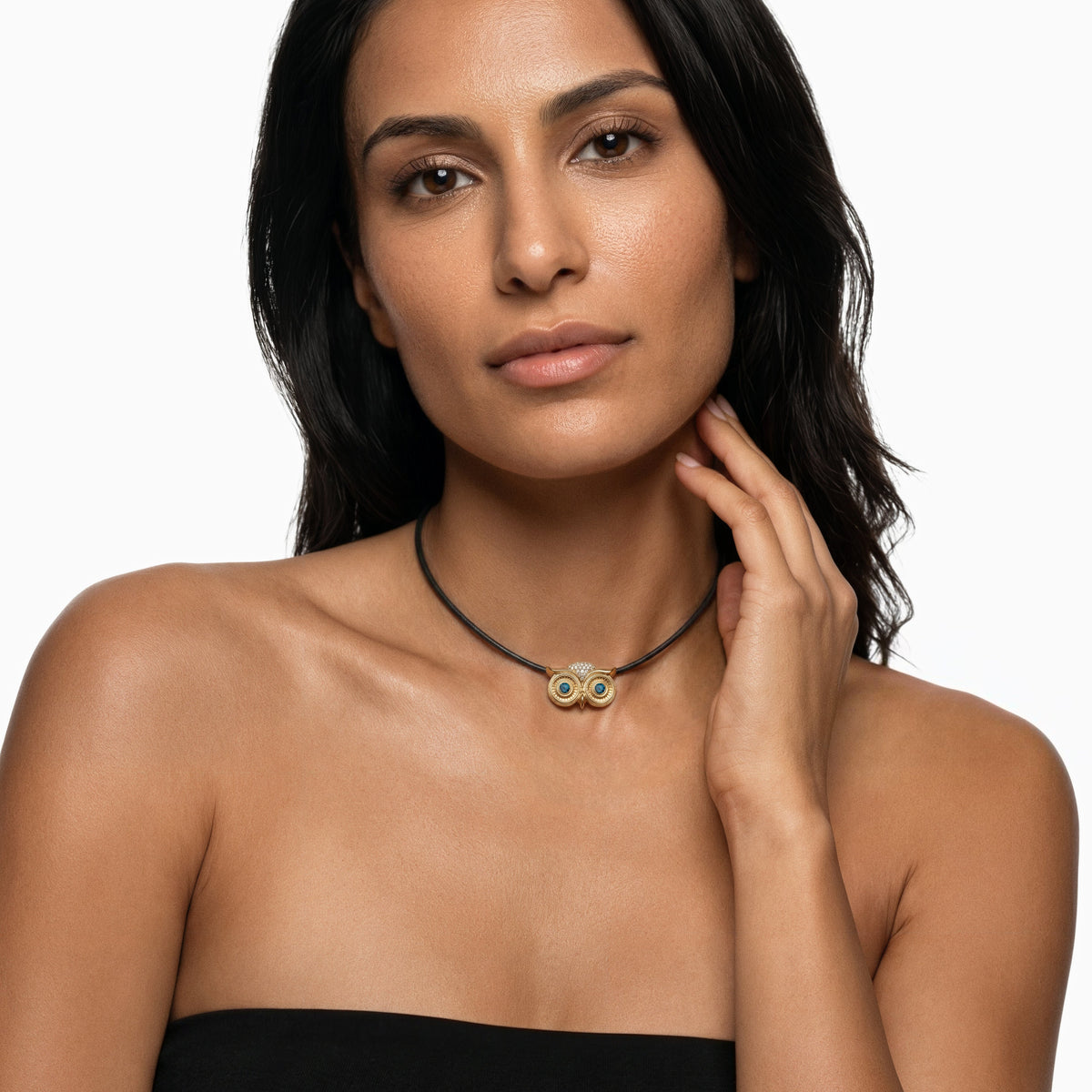 Athena Necklace in 14k yellow gold and a leather cord with blue diamond eyes by SELIN KENT, on a model