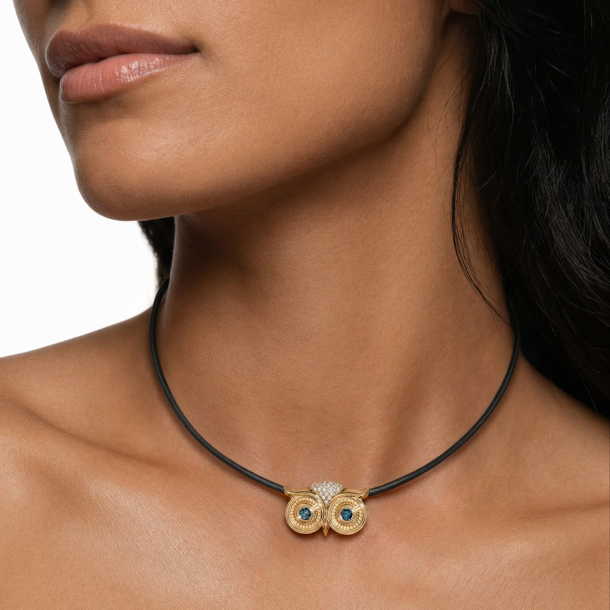 Athena Necklace in 14k yellow gold and a leather cord with blue diamond eyes by SELIN KENT, on a model 