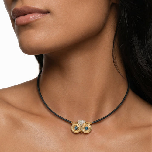 Athena Necklace in 14k yellow gold and a leather cord with blue diamond eyes by SELIN KENT, on a model 